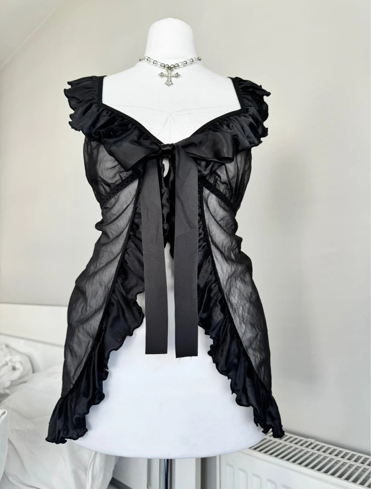 Black top with a bow an ruffles