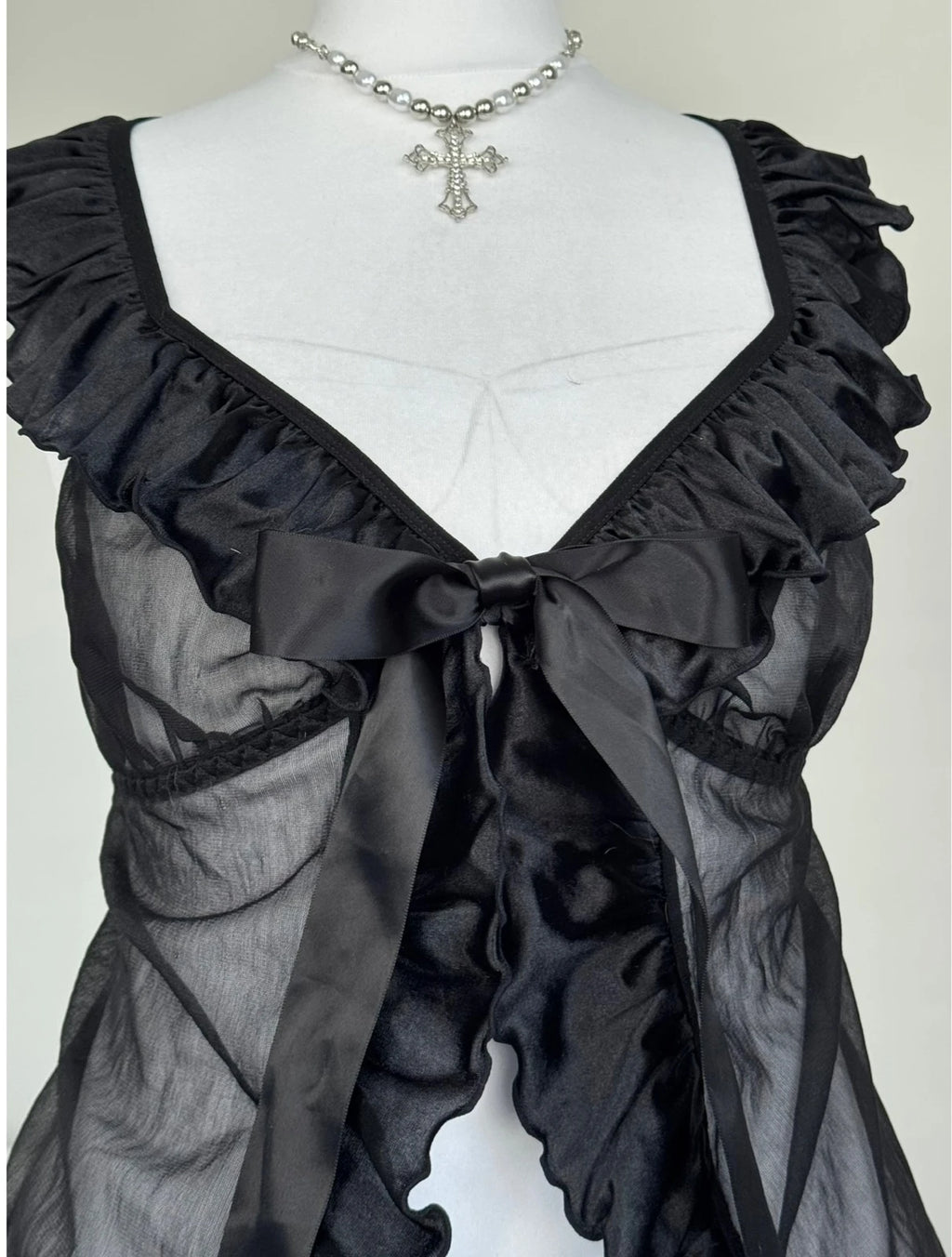 Black top with a bow an ruffles