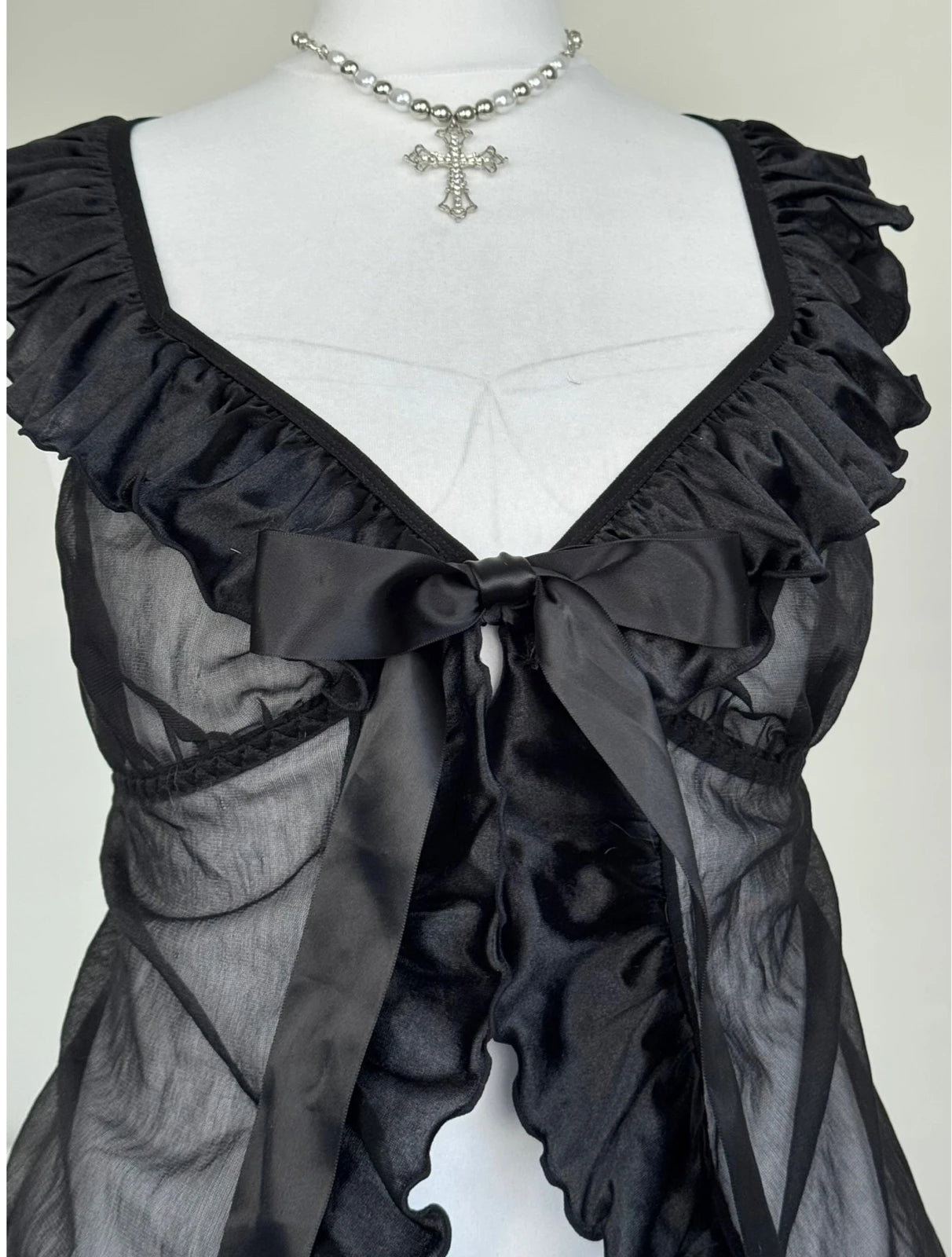 Black top with a bow an ruffles
