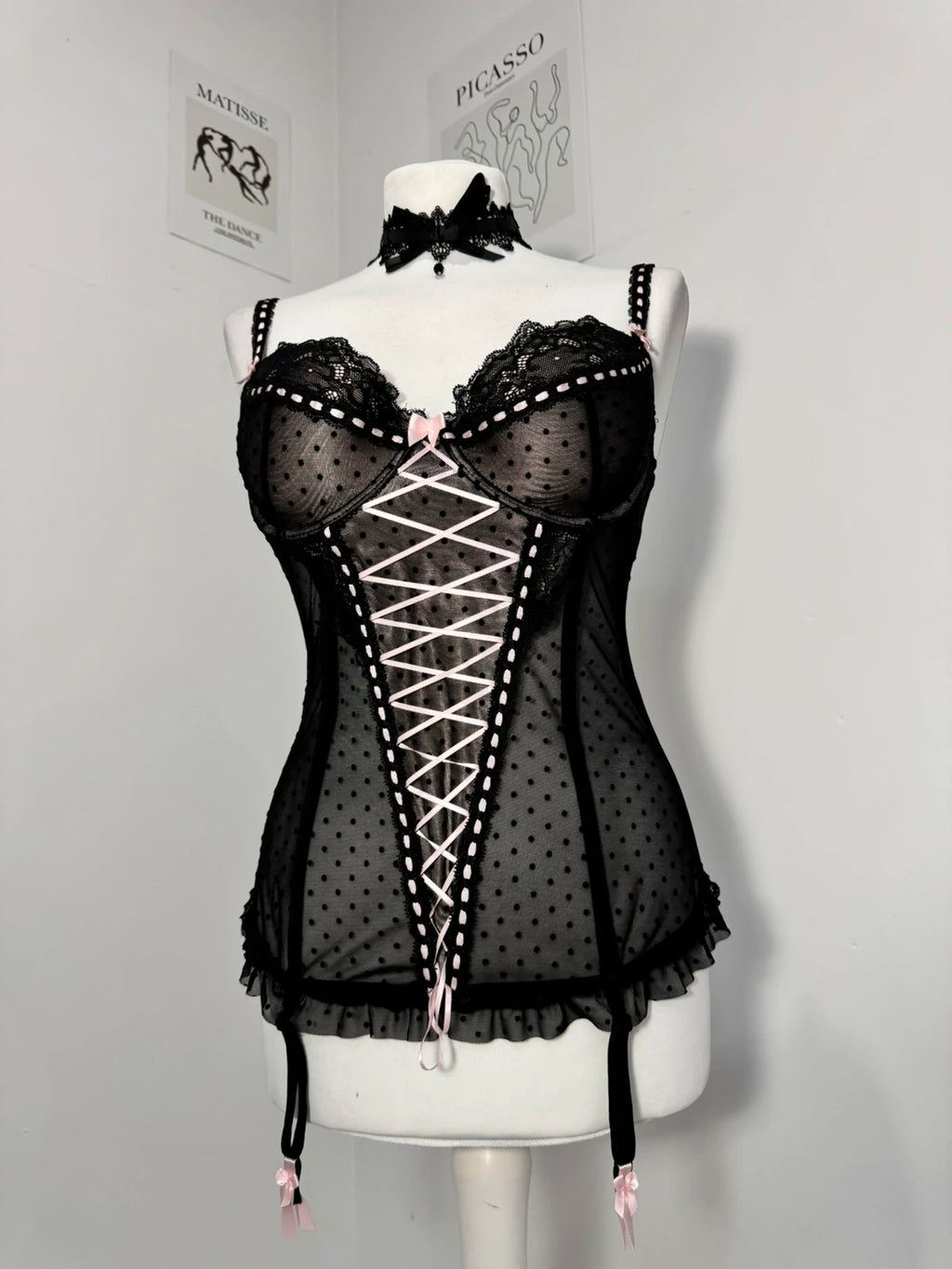Black polka dot lace-up corset with a little bow