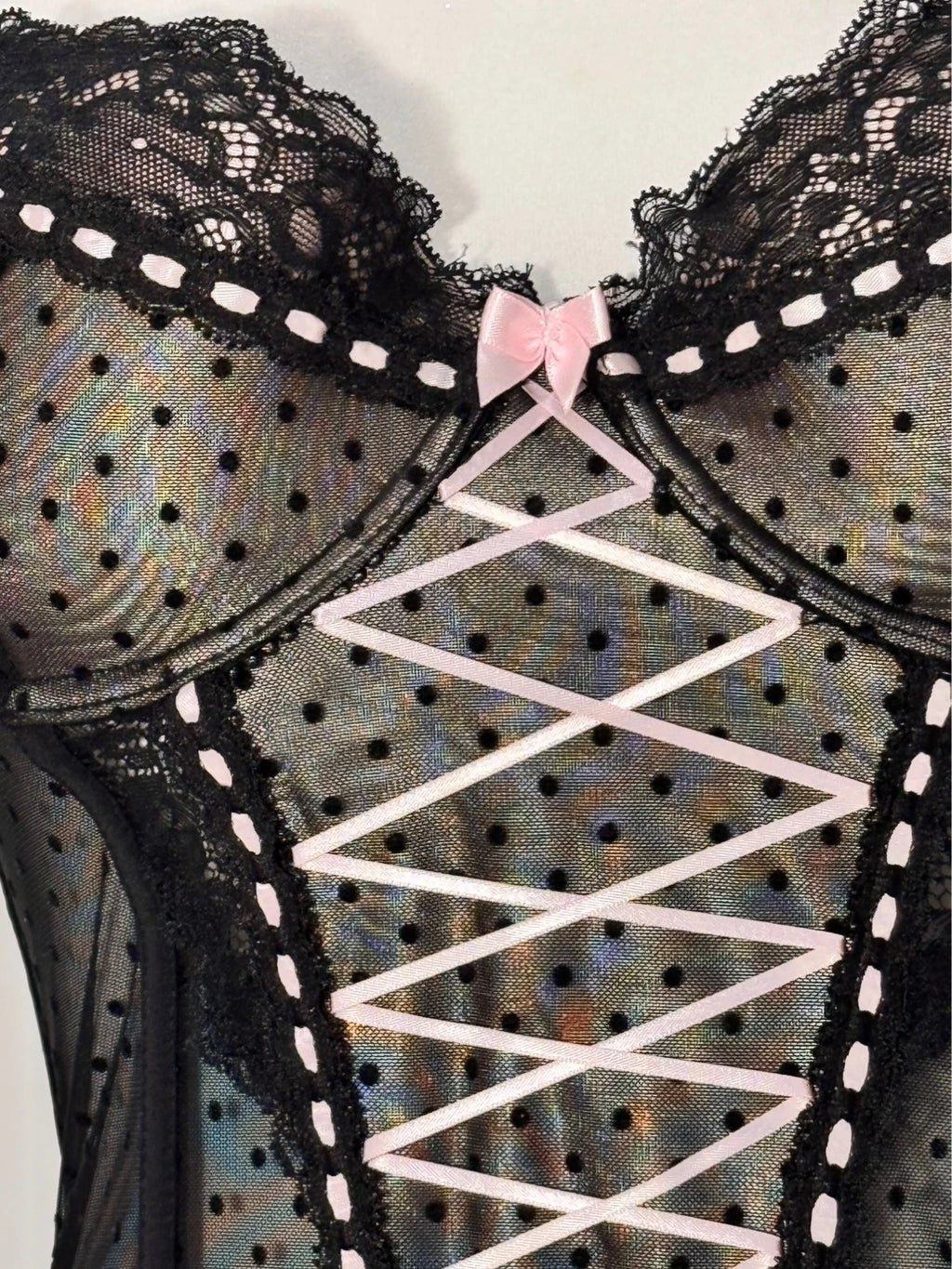 Black polka dot lace-up corset with a little bow