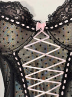 Black polka dot lace-up corset with a little bow