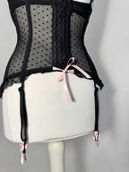 Black polka dot lace-up corset with a little bow