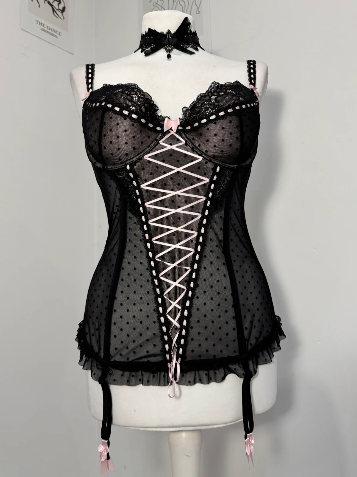 Black polka dot lace-up corset with a little bow