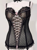 Black polka dot lace-up corset with a little bow