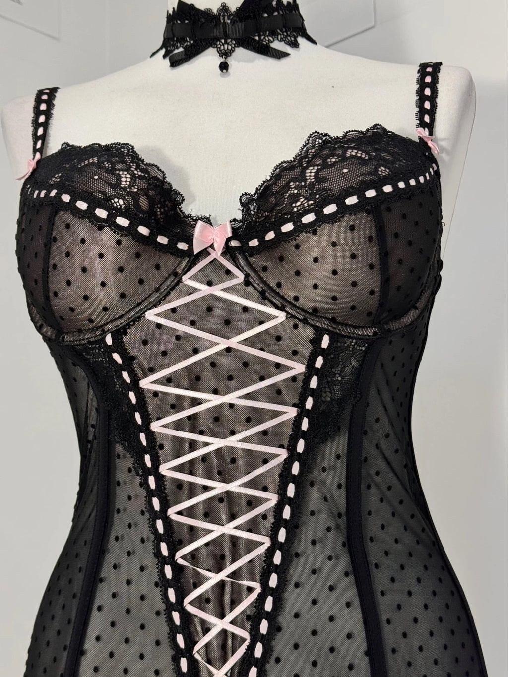 Black polka dot lace-up corset with a little bow