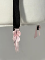 Black polka dot lace-up corset with a little bow