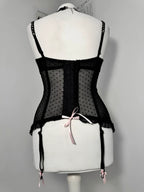 Black polka dot lace-up corset with a little bow