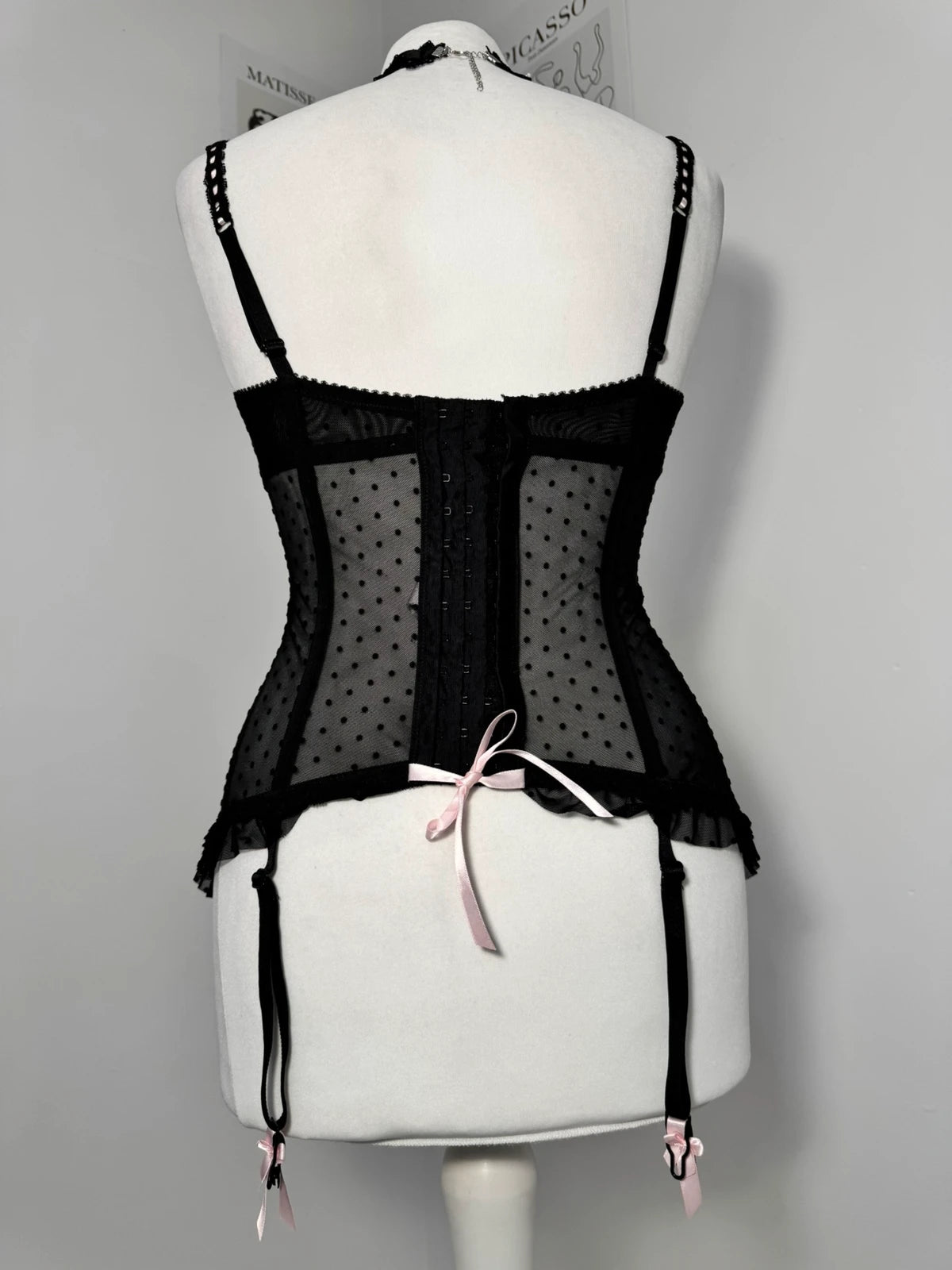 Black polka dot lace-up corset with a little bow
