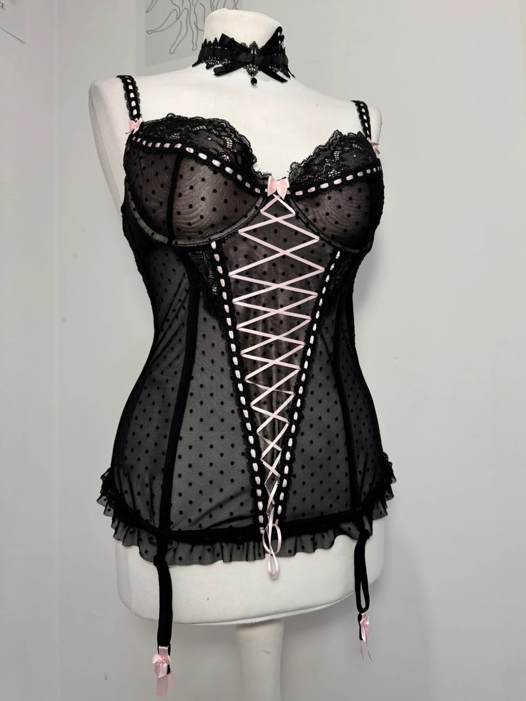 Black polka dot lace-up corset with a little bow