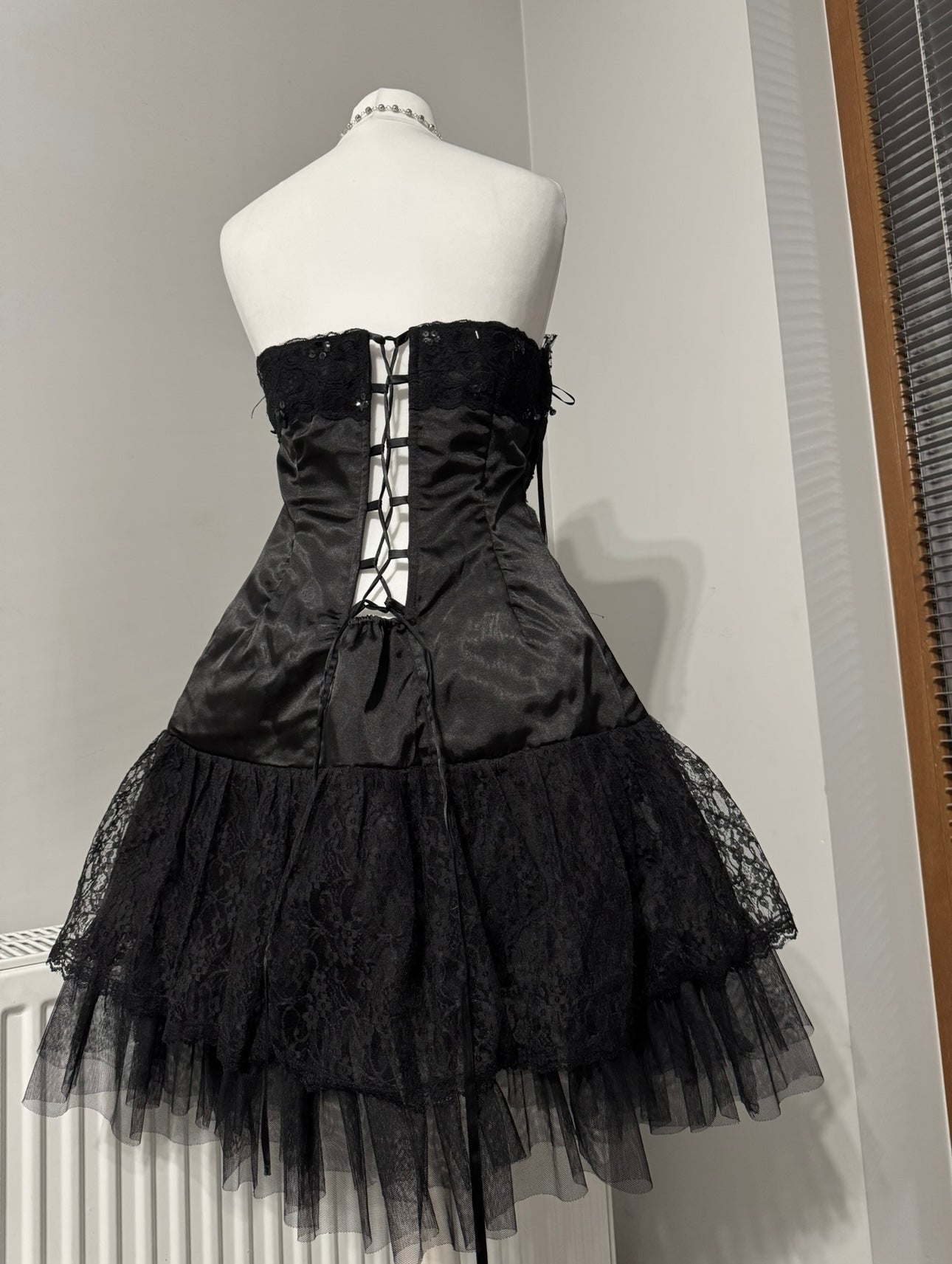Black dark coquette mini dress with a flower detail