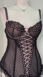 Black polka dot lace-up corset with a little bow